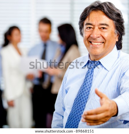 Welcoming business man ready to handshake with hand extended