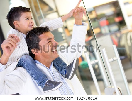 Father and son at the shopping center looking at a window