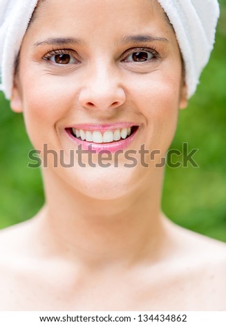 Happy woman after taking a bath with a towel wrapped in her head