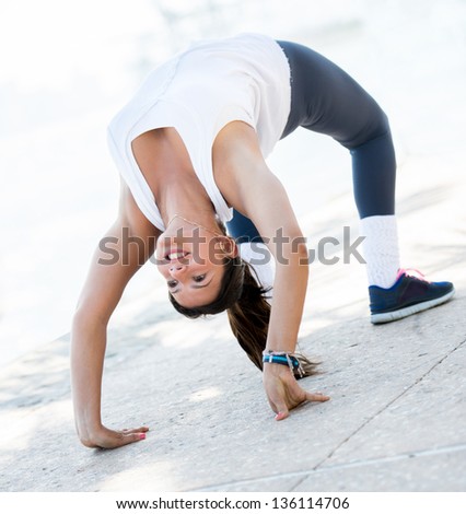 Flexible woman stretching her back making an arch
