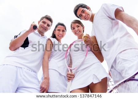 Group of tennis players looking happy and smiling