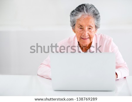 Elder woman using a laptop computer at home