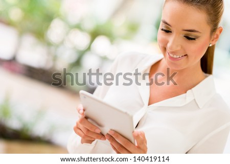 Business woman using app on a tablet computer