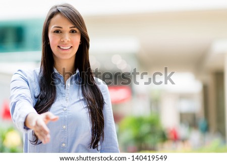 Business woman with arm extended for a handshake