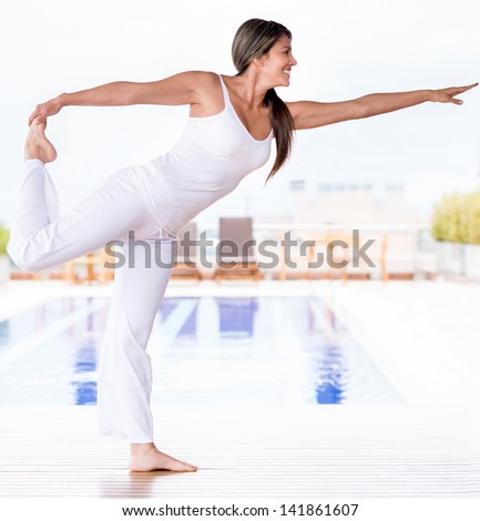 Beautiful woman doing yoga exercises and living a healthy lifestyle