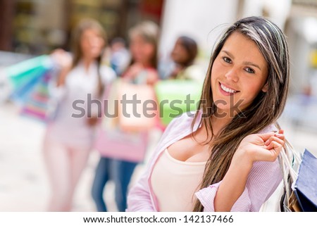 Happy female shopper at the shopping center with her friends