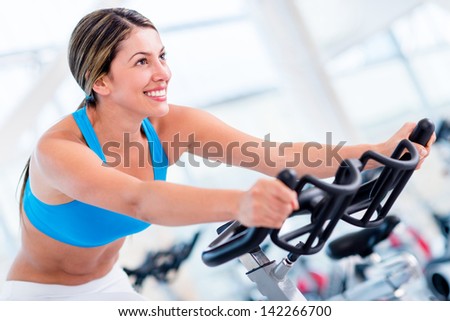 Fit woman working out at the gym and looking happy