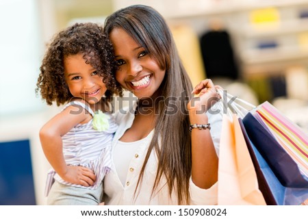 Happy mother and daughter shopping at a retail store