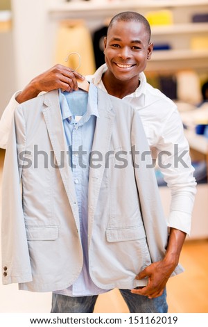 Happy man shopping for clothes at a retail store
