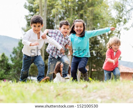 Happy group of kids playing at the park