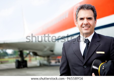 Handsome airplane pilot at the airport smiling