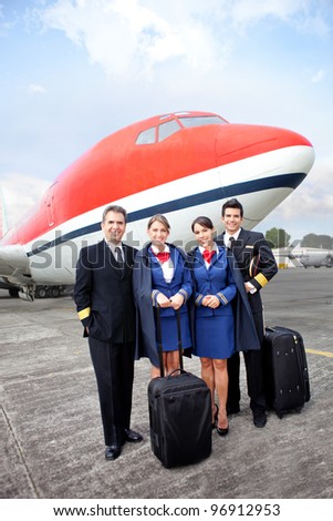 Airplane cabin crew standing at the airport with bags