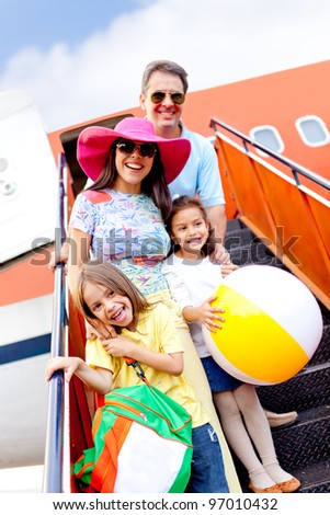 Happy family going on holidays by airplane