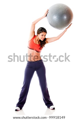 Woman doing pilates with a Swiss ball - isolated over a white background