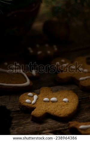 homemade ginger cookies on a wooden background with Christmas scenery. vintage style. selective focus