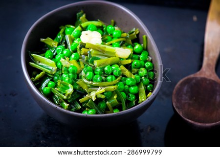 stewed green peas with fried eggs. healthy, pure food. selective focus