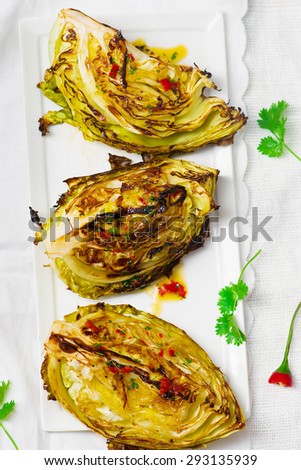 the cabbage baked on a grill with hot sauce. healthy food. style vintage. selective focus.