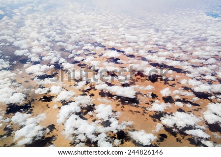 Look at the clouds and the Earth from a height of ten thousand feet, blurred