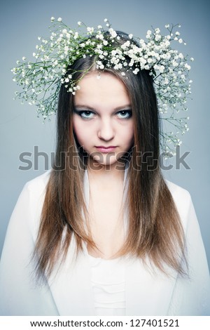spring portrait  girl with wreath of flowers , pastel shades