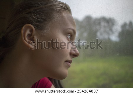 Teenage girl near the train window