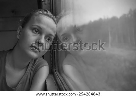 Teenage girl near the train window
