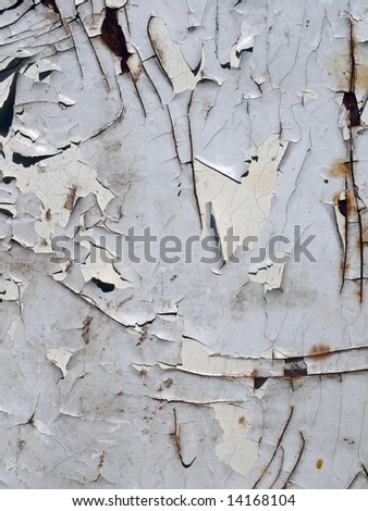 The cracked white paint on an old metallic surface. Vintage background