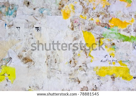 remains of posters and advertisements on old wall