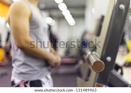 The Fitness Couple in gym. Lifting Weights