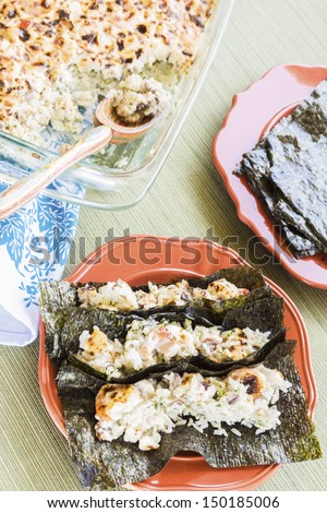 Hawaiian broiled sushi tacos of shrimp, crab, scallops and shiitake mushrooms mixed with sour cream and mayonnaise over furikake seasoned white rice traditionally served on Korean nori sheets