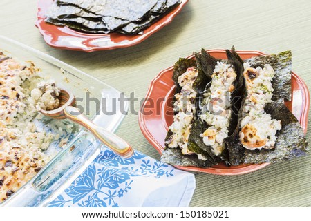 Hawaiian broiled sushi tacos of shrimp, crab, scallops and shiitake mushrooms mixed with sour cream and mayonnaise over furikake seasoned white rice traditionally served on Korean nori sheets