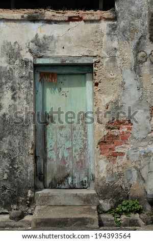 Dirty Door. Old wooden door on a derelict house. This house is in need of repair or renovation. A symbol of urban decay.