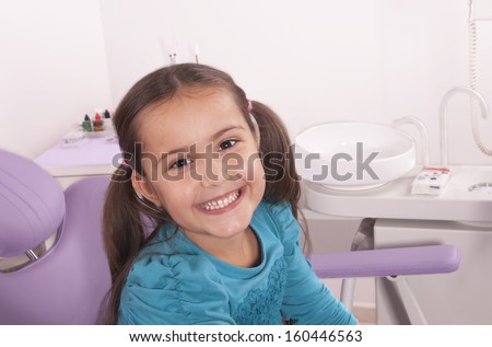 pretty little girl smiling in the dentist chair