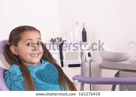 pretty little girl in dental office waiting for doctor