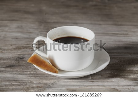 Coffee cup whit cheese center on wooden table