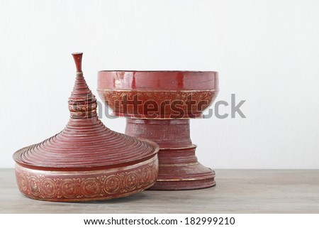 Antique red lacquer wares on wooden table white background (Still life)