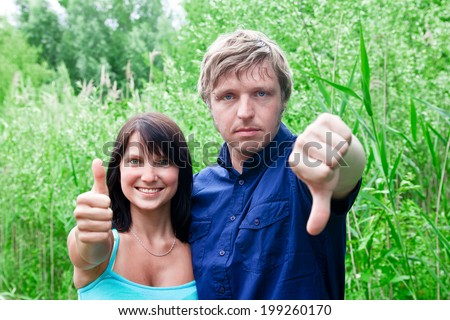 Couple showing thumbs up and thumbs down