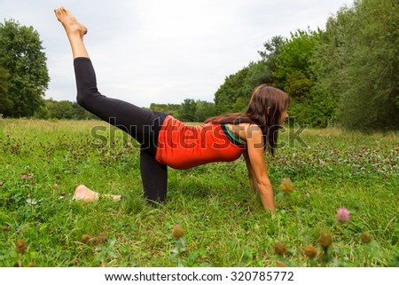 a pregnant woman doing yoga in the park