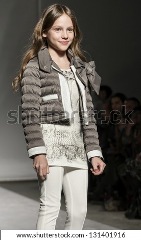 NEW YORK - MARCH 10: A model is walking the runway at Miss Blumarine Kids Collection Show for Fall/Winter 2013 during NY Kids Fashion Week at Industria Super Studio on March 10, 2013 in New York