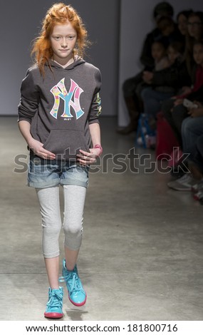 NEW YORK - MARCH 08 2014: A model is walking the runway at CCandy Clothing 2014 Fall Collection Show during petitePARADE Kids Fashion Week