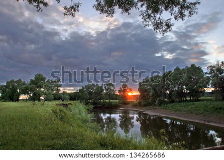 beautiful sunset on the river is reflected in water