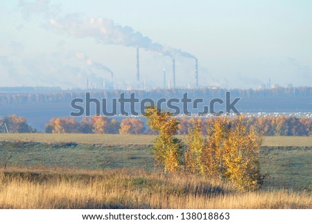 autumn landscape with fields and trees, heat station on the horizon