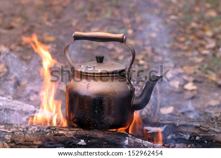 close-up of a kettle on the fire in the autumn