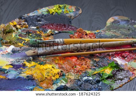 macro artist\'s palette, texture mixed oil paints in different colors and saturation studio