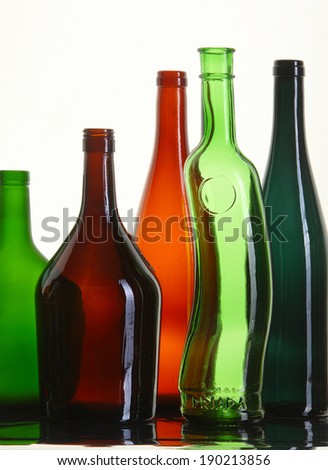 close-up of beautiful colorful empty bottles without caps isolated on white background studio