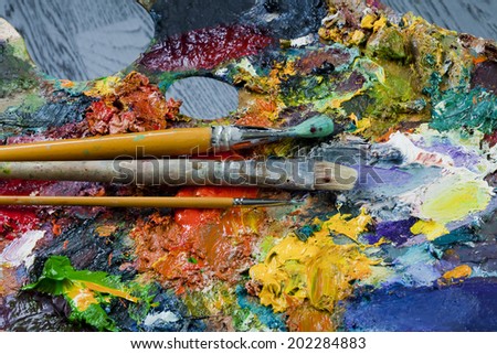 macro artist's palette, texture mixed oil paints in different colors and saturation studio