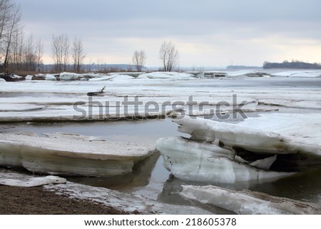 landscape ice drift on the river in early spring on a cloudy day