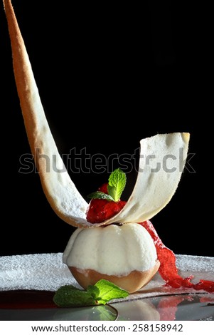 macro elegant holiday dessert on a white plate decorated with chocolate and jam