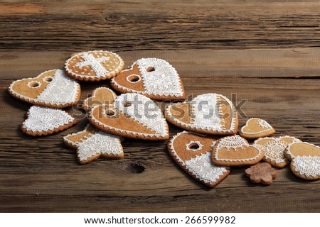 macro gingerbread heart-shaped with a yellow ribbon, flowers on wood background studio