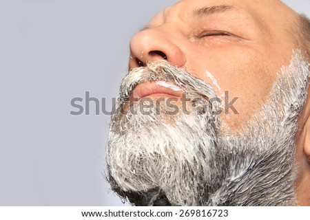 close-up portrait of an adult male color beard and mustache on white background studio