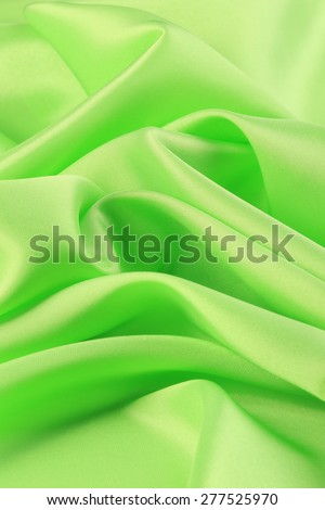 macro texture smooth satin fabric light green color studio